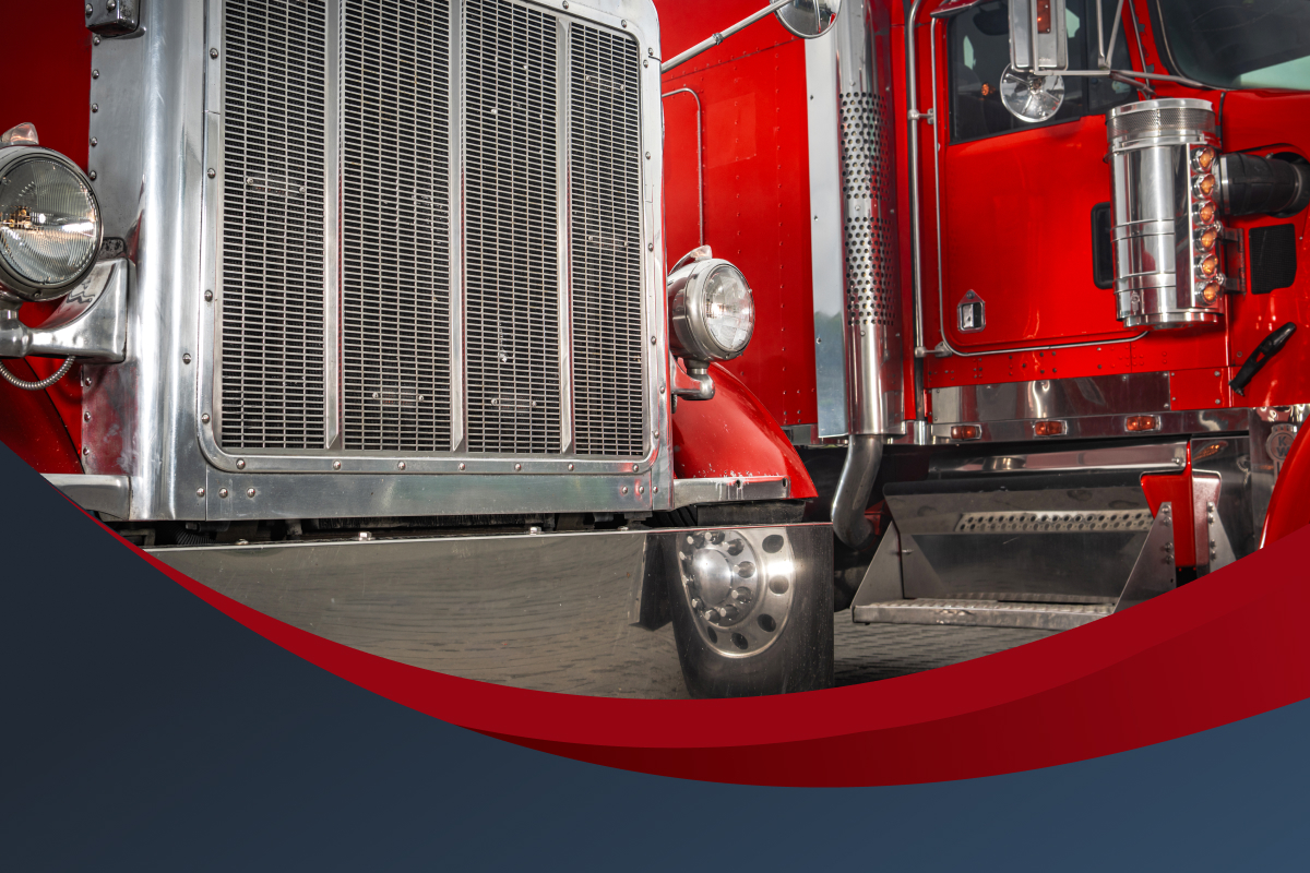 A row of Peterbilt trucks sit ready to drive.